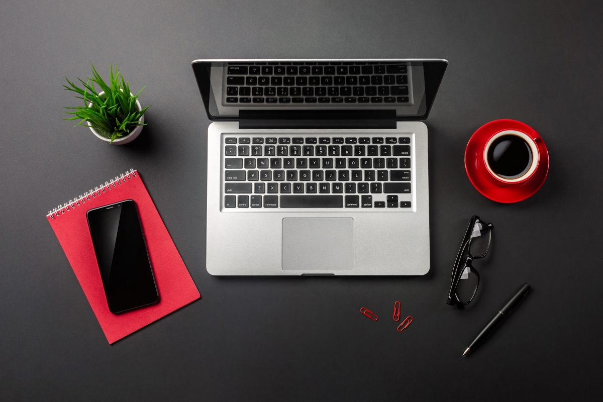 black-office-desk-table-with-blank-screen-laptop-computer-notebook-mobile-phone-red-cup-coffee-top-view_1200x800.jpg