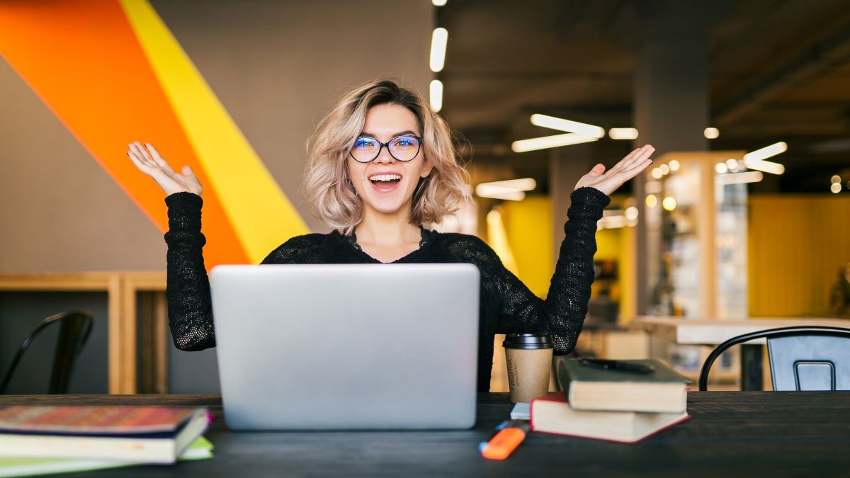 funny-happy-excited-young-pretty-woman-sitting-table-black-shirt-working-laptop-co-working-office-wearing-glasses_1200x675-20230809-061350.jpg