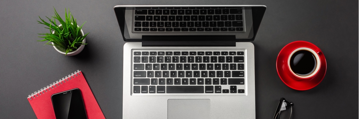 black-office-desk-table-with-blank-screen-laptop-computer-notebook-mobile-phone-red-cup-coffee-top-view_1200x400.jpg