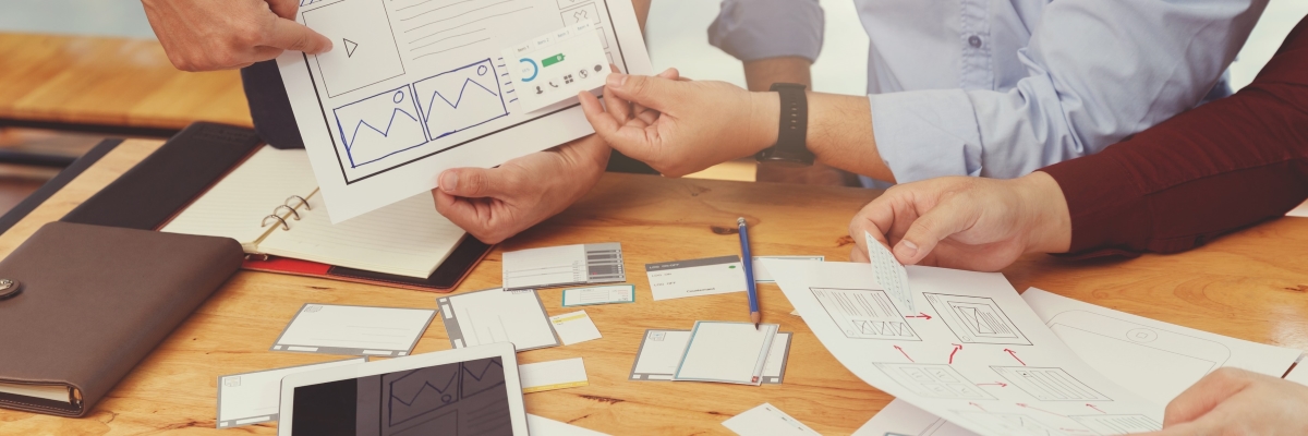 ux-ui-concept-graphic-designers-work-together-with-ux-ui-designer-planning-application-template-layout-framework-mobile-phone-computer-mobile-vintage-effect_1200x400.jpg
